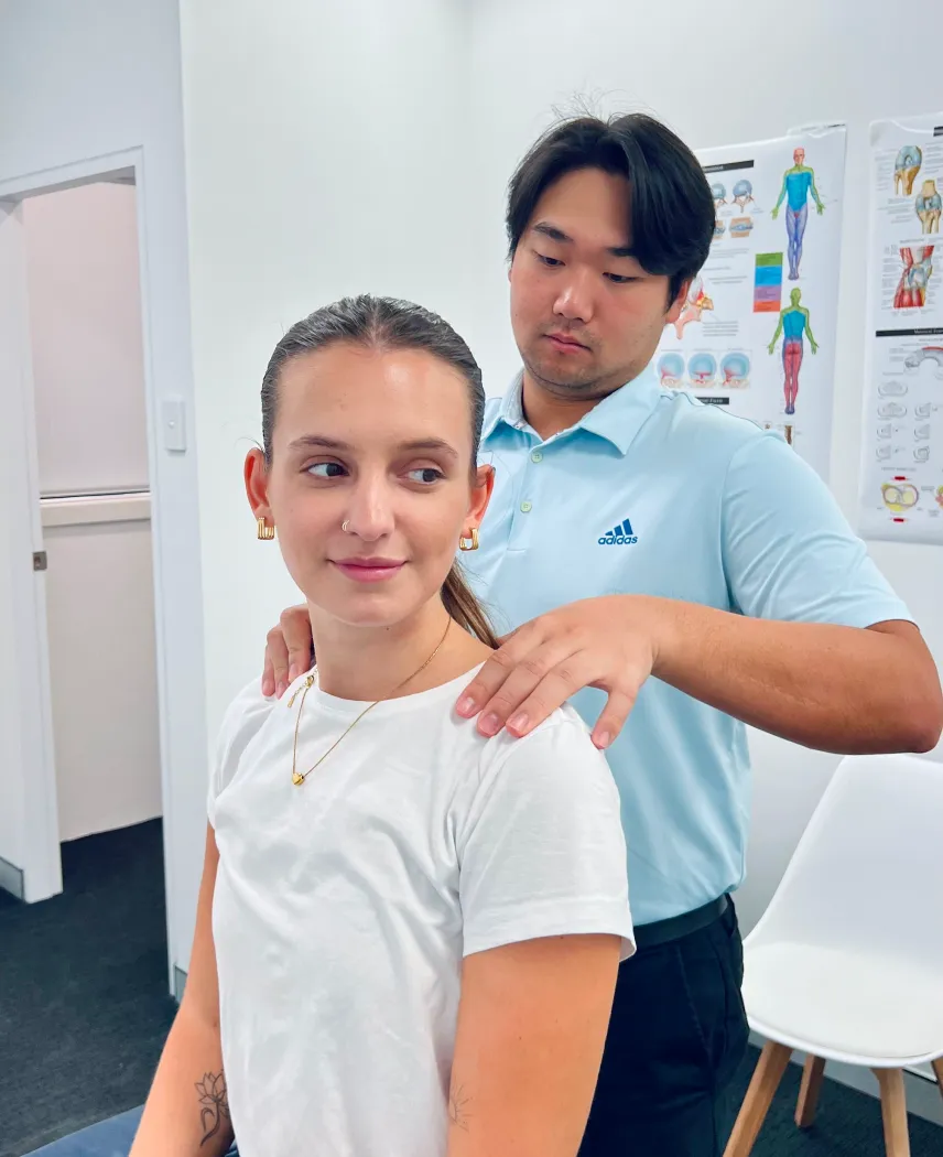 Practitioner examining a patient’s shoulder