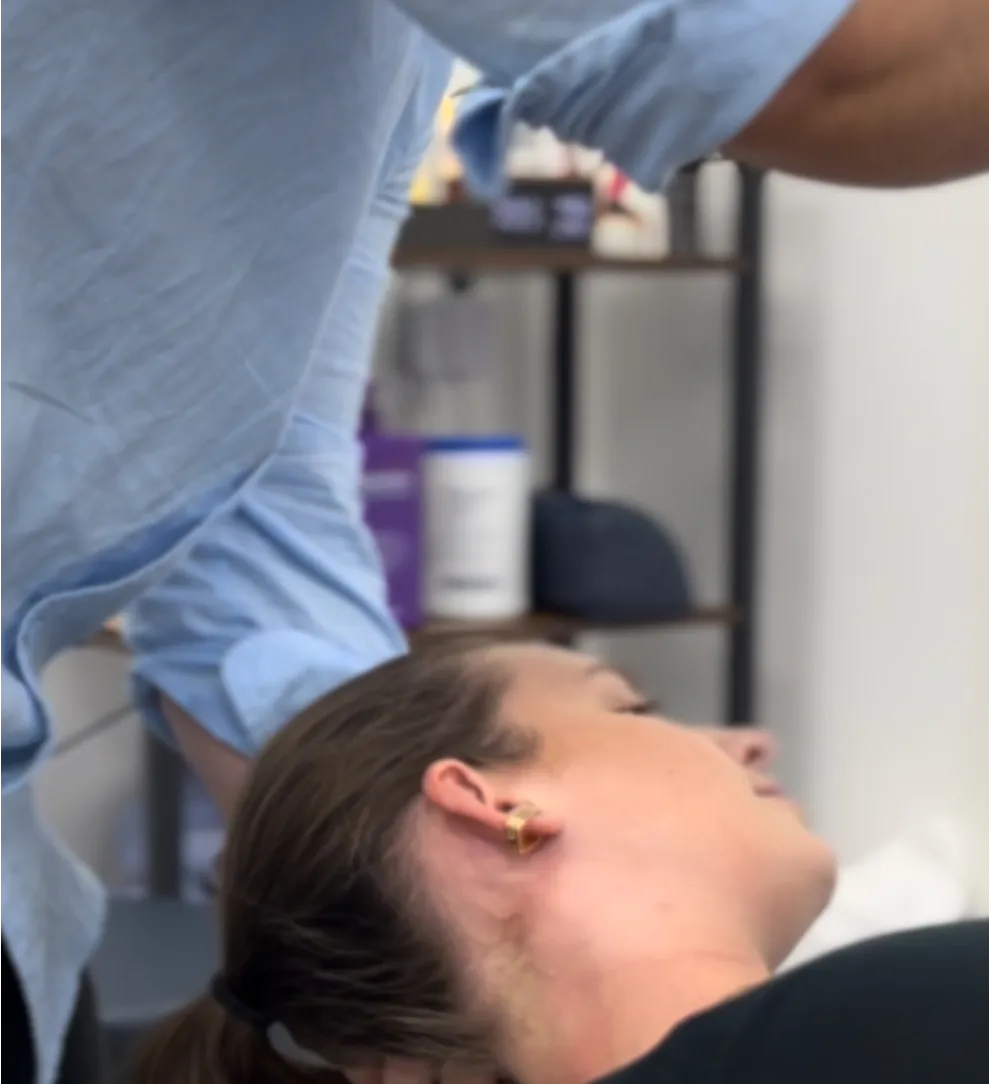 Practitioner assessing a patient with headaches